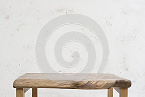 Small wooden table on abstract rough handmade wall background