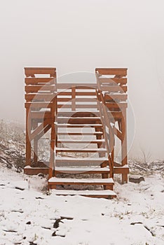 Small wooden view tower on Stribrna hora hill in winter Zlatohorska vrchovina mountains on czech - polish borders