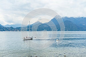 Small yacht docked in the marina of Varenna, one of the most picturesque towns on the shore of Lake Como. Varenna, Italy