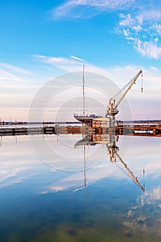 Small yacht under repair in an old dock