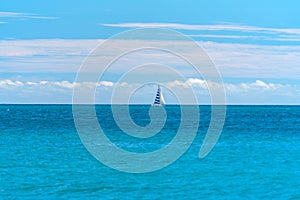 Small yacht under sail in the open sea