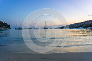 Small yachts anchored in quiet water before the dawn