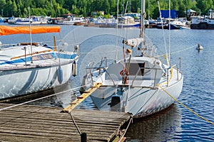 Small yachts moored at a wooden pier