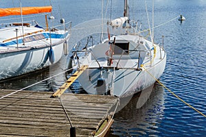 Small yachts moored at a wooden pier