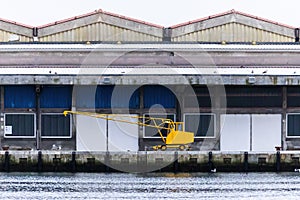 Small yellow crane for unloading in the docks