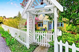 Small Yellow house exterior with White picket fence