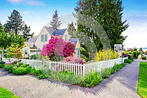 Small Yellow house exterior with White picket fence photo