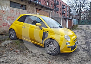 Small yellow Italian car Fiat 600 parked
