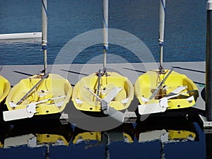 Small Yellow Sail Boats Sitting On Dock