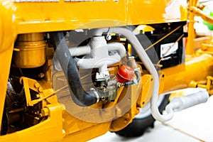 Small yellow tractor in exhibition, closeup details, wheels