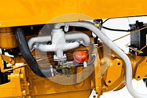 Small yellow tractor in exhibition, closeup details, wheels