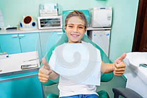 Small, young patient boy is happy with a visit to the dentist. Concept of painless dental treatment. Beautiful, wide smile of a