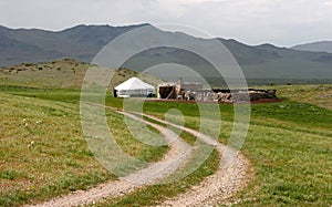 Small yurt in Mongolia. Mountains  on the background of the steppe.