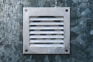 Small zinc metal plated ventilation grille on the wall