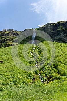 Smaller waterfall next to Seljalandsfoss waterfall in Iceland in summer