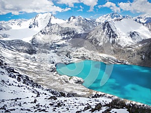 Smaragd water of misty Ala Kul lake in Terskey Alatoo mountain photo