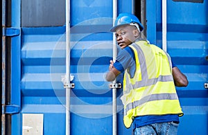 Smart african american engineer man wearing industrial work wear coverall and protective helmet doing stock check and close the