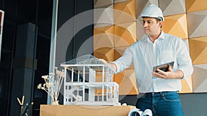 Smart architect engineer using tablet analysis house construction. Manipulator.