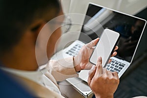 Smart Asian businessman using his smartphone during the flight. close-up image