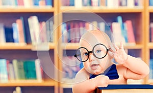 Smart Baby in Glasses with Book, Little Child in School Library