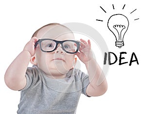 Smart baby with glasses has an idea