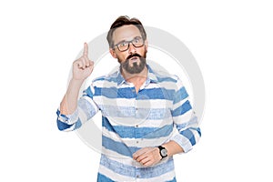 Smart bearded man keeping his index finger up