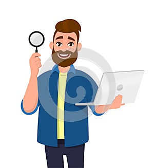 Smart bearded young man showing/holding magnifying glass and laptop computer in hand. Search, find, discovery, analyze, inspect.