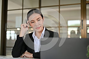 Smart and beautiful young Asian businesswoman thinking an ideas, working in the office