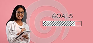 Smart black female student taking notes in copybook on pink background, collage with GOALS loading process bar