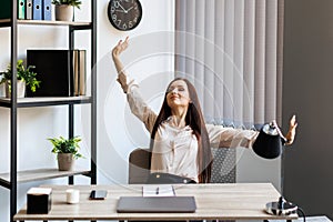 Smart business woman in formal suit outfit sitting and stretch relax in front of computer with happy and smile in modern office