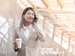 Smart business woman in a suit with mobile phone.