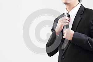 Smart Businessman adjust his tie before start with job