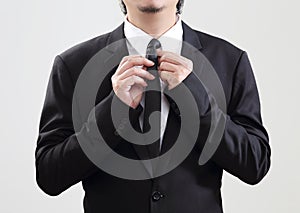 Smart Businessman adjust his tie before start with job