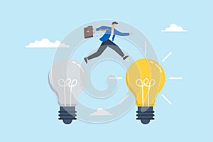 Smart businessman jump from old to new shiny light bulb, illustrating of business transformation