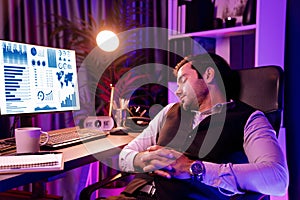 Smart businessman leaning on chair with working desk. Surmise.