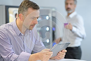 smart businessman using digital tablet in office photo