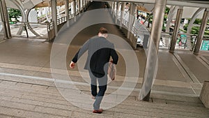 Smart businessman walking down stair and hurry to walking back to home. Urbane. photo