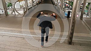 Smart businessman walking down stair and hurry to walking back to home. Urbane. photo