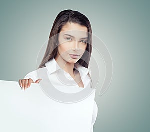 Smart businesswoman showing white empty paper banner background with copy space for advertisiment. Business success photo