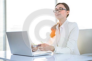 Smart businesswoman using her laptop