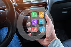 Smart car app in driver hand on modern smart phone with round edges