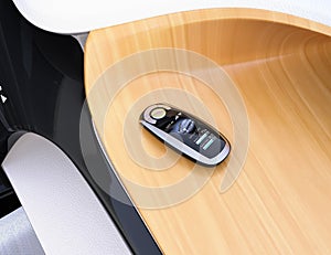 Smart car key on electric car`s dashboard