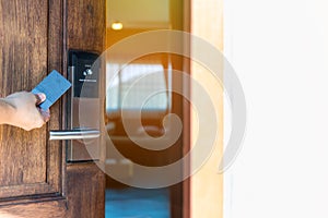 Smart card door key lock system in hotel. Hotel electronic lock on wooden door. Entrance door with electronic card lock security.