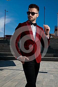 Smart casual man wearing red velvet tuxedo and sunglasses