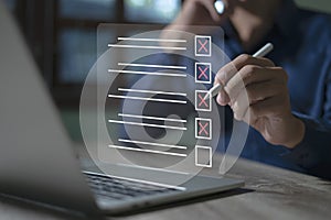 Smart checklist concept on virtual screen A man uses a marker to explore topics in a digital form review document
