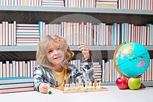 Smart child. Clever concentrated and thinking kid playing chess. Kids brain development and logic game.