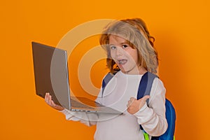 Smart child, clever school kid. School child with thumb up using laptop computer. Portrait of school boy isolated on