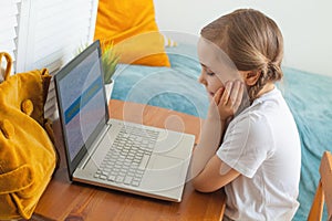 Smart child girl learning at home. Distance education, hobby and leisure activity concept