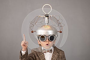 Smart child wearing funny helmet with illuminated lightbulb