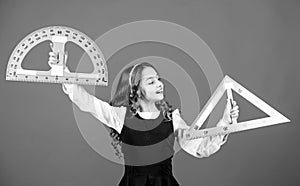 Smart and clever concept. Girl with big ruler. School student study geometry. Kid school uniform hold ruler. School